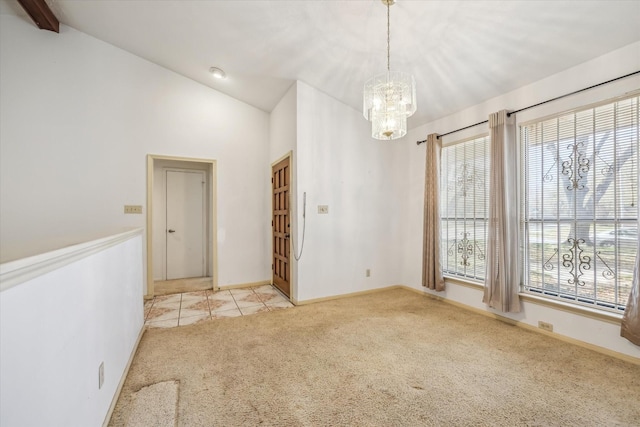 carpeted empty room with tile patterned flooring, a notable chandelier, baseboards, and lofted ceiling