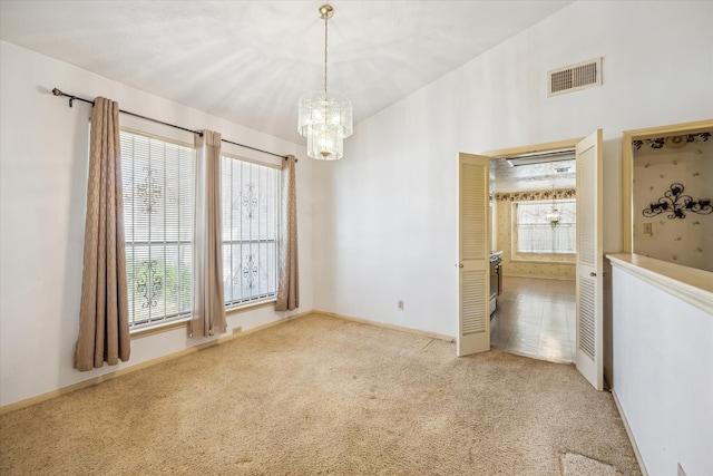 unfurnished room featuring carpet, visible vents, and baseboards