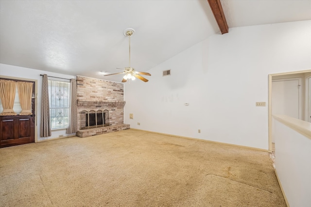 unfurnished living room with visible vents, a brick fireplace, ceiling fan, beamed ceiling, and carpet floors