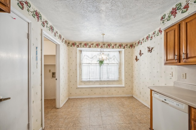 kitchen featuring a textured ceiling, dishwasher, brown cabinetry, and wallpapered walls