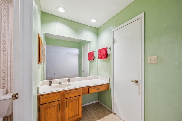 bathroom featuring vanity and toilet