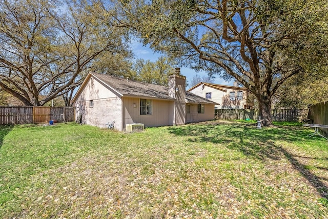 view of yard featuring central air condition unit and a fenced backyard