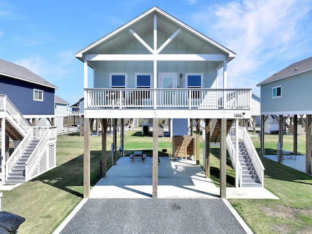 exterior space with a carport, a lawn, and board and batten siding