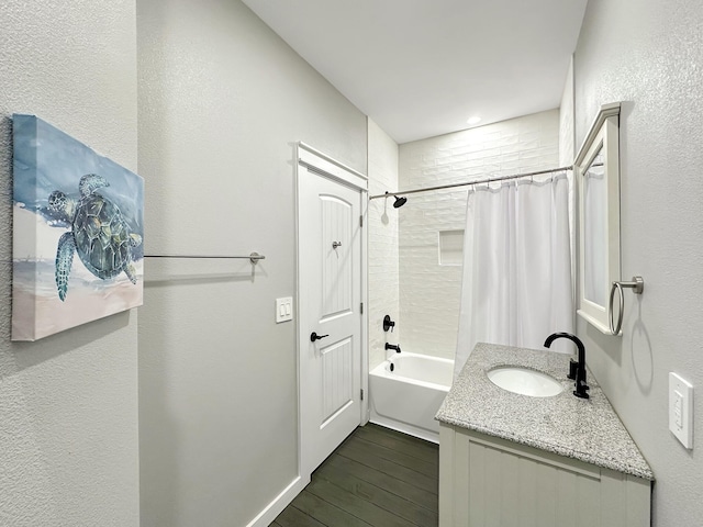 full bathroom featuring vanity, shower / bath combo with shower curtain, and wood finished floors