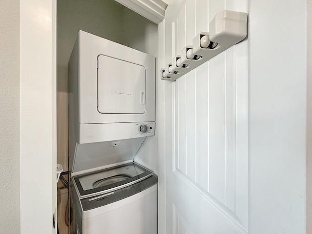 laundry area featuring laundry area and stacked washer / drying machine