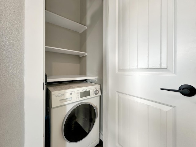 laundry room featuring laundry area and washer / dryer