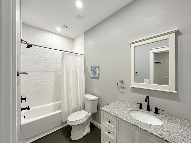 bathroom featuring visible vents, toilet, wood finished floors, and shower / bath combination with curtain