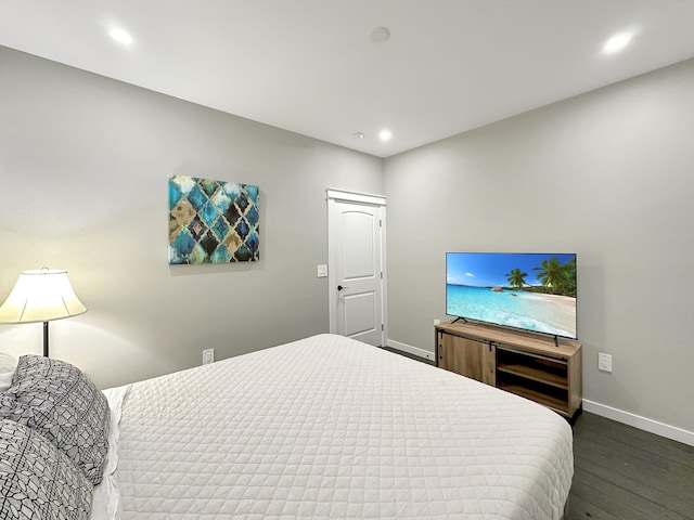 bedroom with dark wood finished floors, recessed lighting, and baseboards