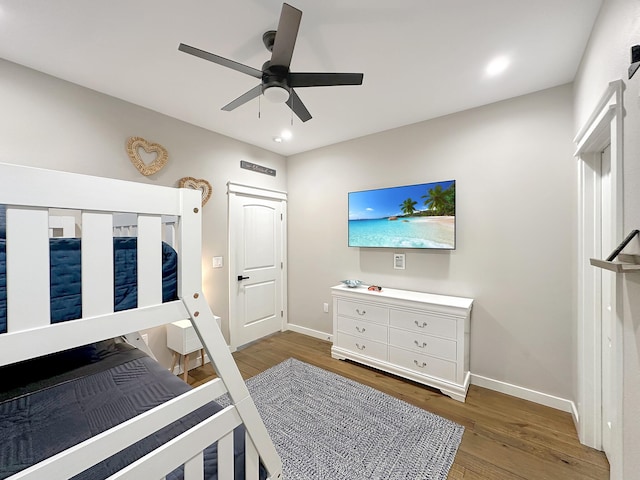 bedroom with baseboards, wood finished floors, and a ceiling fan