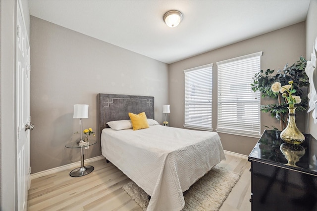 bedroom featuring baseboards and wood finished floors