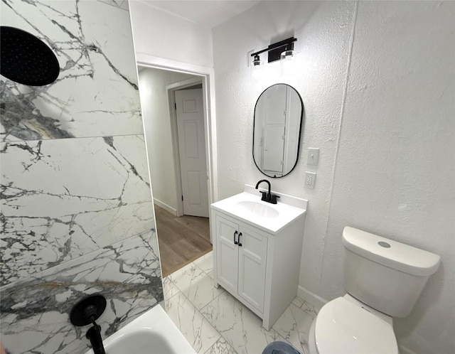 318 S Fulton St, Texas City, TX 77591 - bathroom with vanity, marble finish floor, toilet, baseboards, and a tub