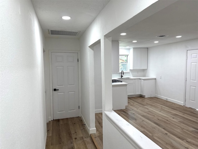 318 S Fulton St, Texas City, TX 77591 - hall featuring visible vents, recessed lighting, light wood-style flooring, and baseboards