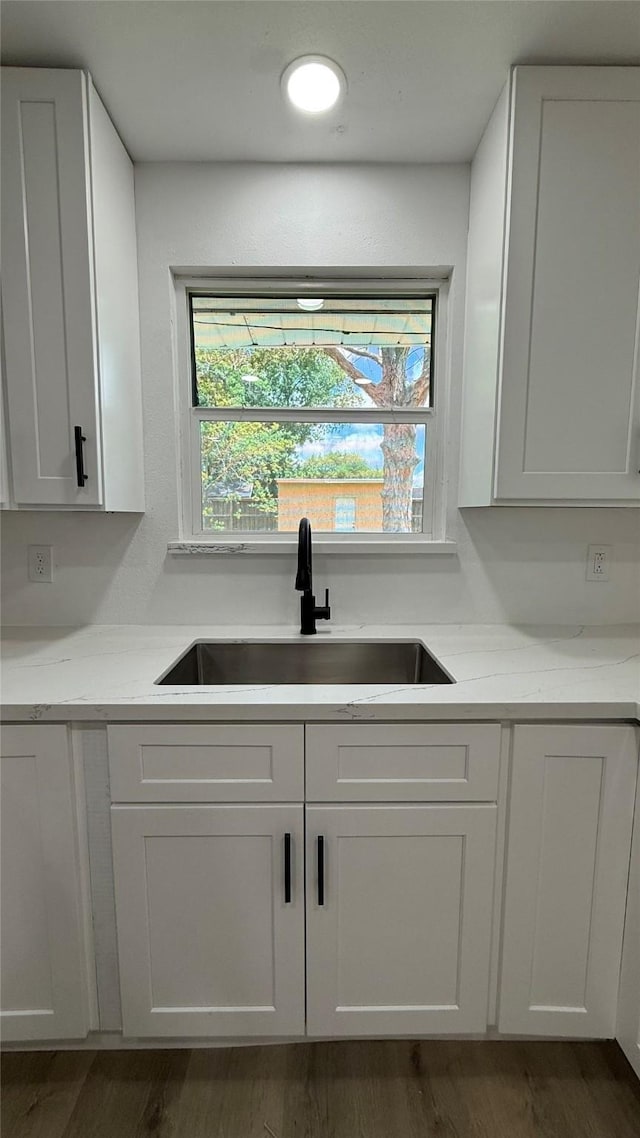 318 S Fulton St, Texas City, TX 77591 - kitchen featuring dark wood-type flooring, a sink, and white cabinetry