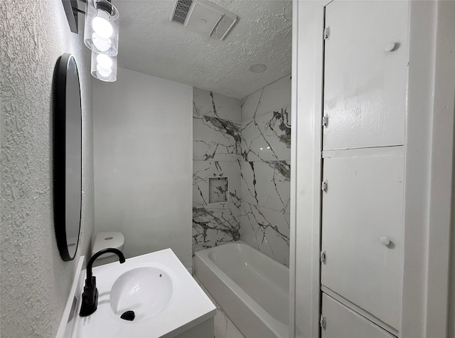 318 S Fulton St, Texas City, TX 77591 - full bathroom with vanity, a textured ceiling, visible vents, and shower / washtub combination