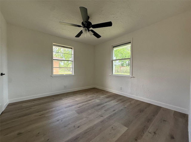318 S Fulton St, Texas City, TX 77591 - unfurnished room featuring plenty of natural light, baseboards, ceiling fan, and wood finished floors