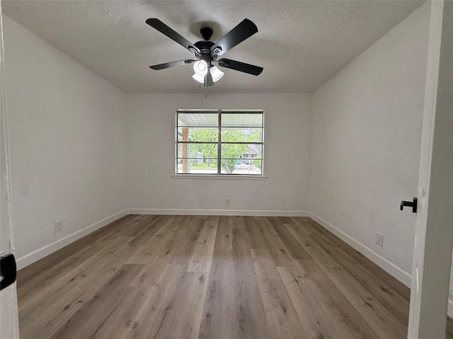 318 S Fulton St, Texas City, TX 77591 - empty room with baseboards, a textured ceiling, and wood finished floors