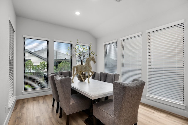 dining area featuring lofted ceiling, light wood-style flooring, recessed lighting, and baseboards