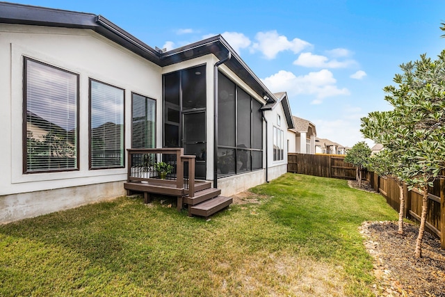 view of yard featuring a fenced backyard and a sunroom