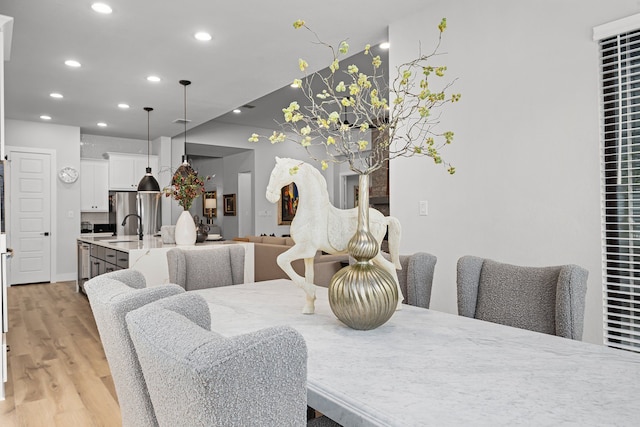 dining space featuring recessed lighting and light wood-style floors