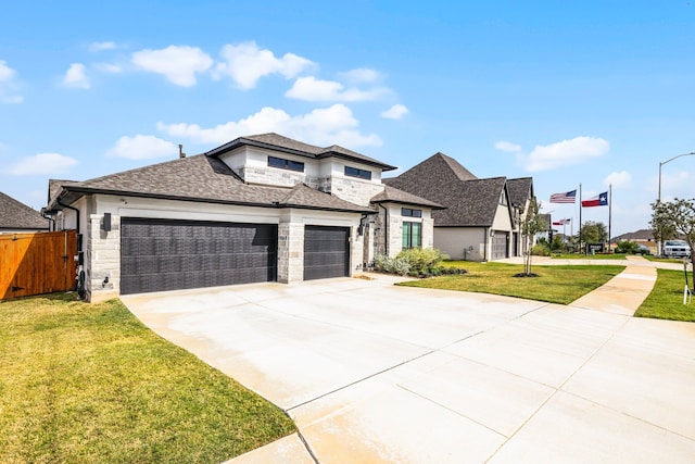 view of front facade with a front lawn, stone siding, fence, concrete driveway, and a garage