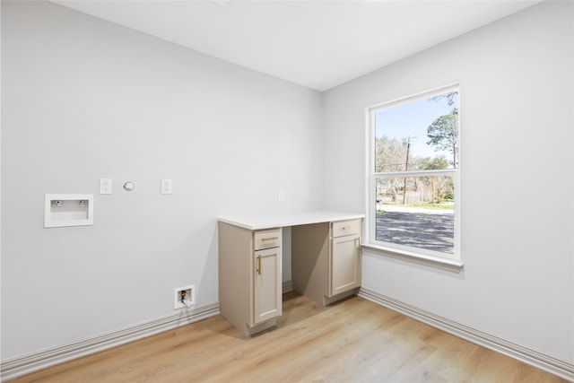 interior space featuring washer hookup and light wood-style floors