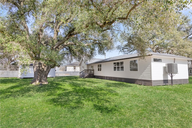 back of house with a lawn and fence