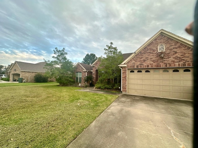 view of yard with concrete driveway and a garage