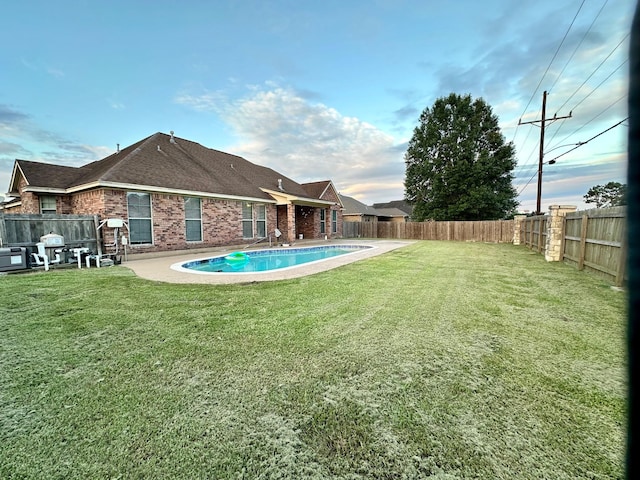 view of yard with a patio, a fenced backyard, and a fenced in pool