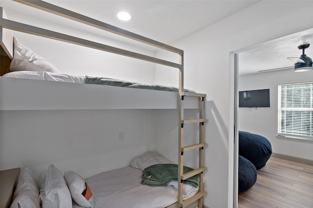 bedroom with recessed lighting and wood finished floors