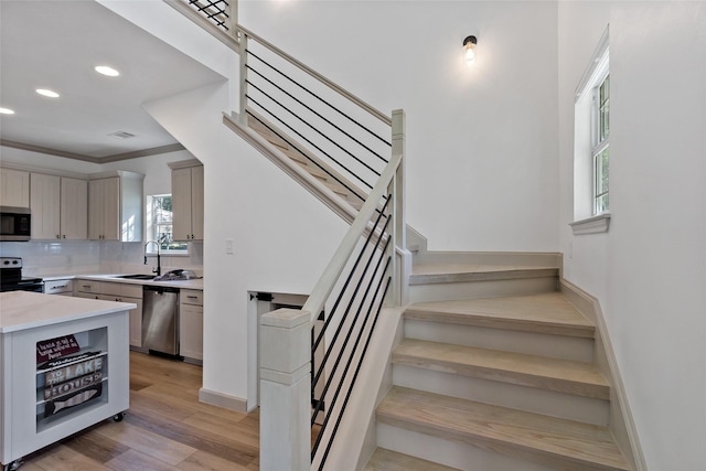 stairs featuring visible vents, baseboards, ornamental molding, recessed lighting, and wood finished floors