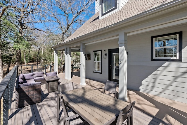 wooden deck with outdoor dining area and an outdoor hangout area