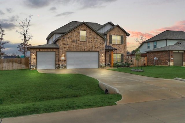 view of front of home with fence, driveway, roof with shingles, a yard, and brick siding