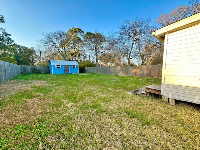 view of yard with an outdoor structure and a fenced backyard