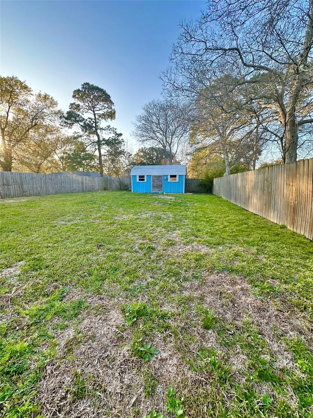 view of yard featuring an outdoor structure and a fenced backyard