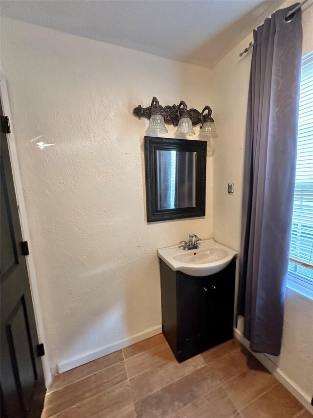 bathroom with vanity and baseboards