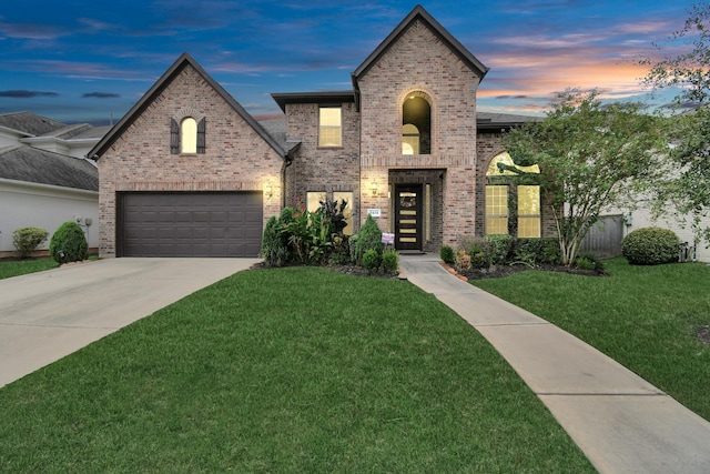 view of front of property featuring brick siding, a garage, concrete driveway, and a front lawn