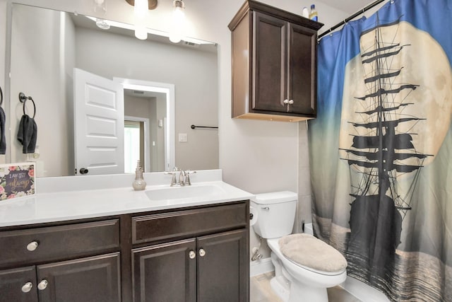 full bathroom with toilet and vanity