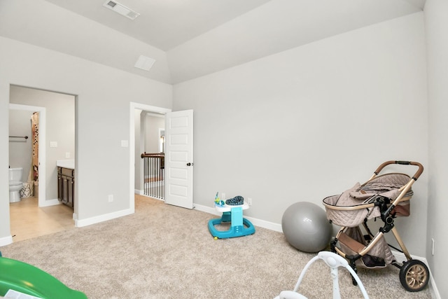 exercise room featuring visible vents, light colored carpet, and baseboards