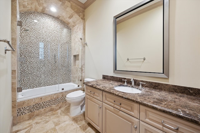 bathroom featuring tiled shower / bath combo, toilet, and vanity