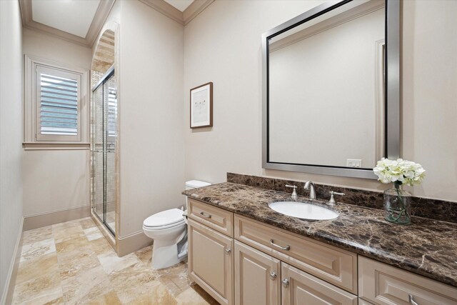 full bath with toilet, a stall shower, vanity, and ornamental molding