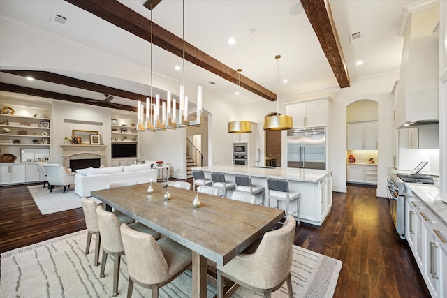 dining area featuring stairs, beamed ceiling, dark wood finished floors, and visible vents