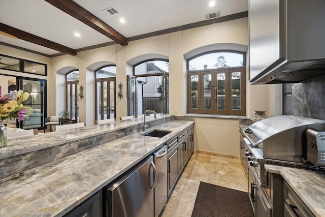 kitchen with visible vents, beamed ceiling, a sink, baseboards, and light stone countertops