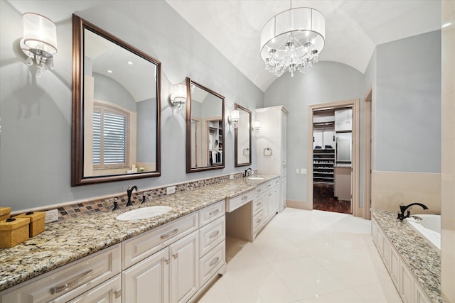 bathroom featuring lofted ceiling, double vanity, baseboards, and a sink