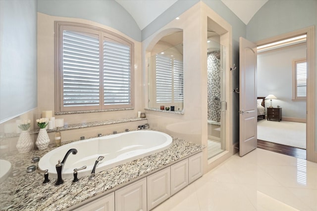 full bath with tile patterned flooring, a garden tub, lofted ceiling, a stall shower, and ensuite bathroom