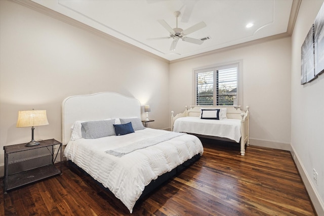 bedroom featuring visible vents, wood finished floors, baseboards, and ornamental molding