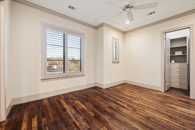 unfurnished bedroom with crown molding, dark wood-style floors, visible vents, and baseboards