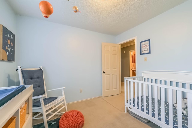 bedroom featuring a textured ceiling and carpet flooring