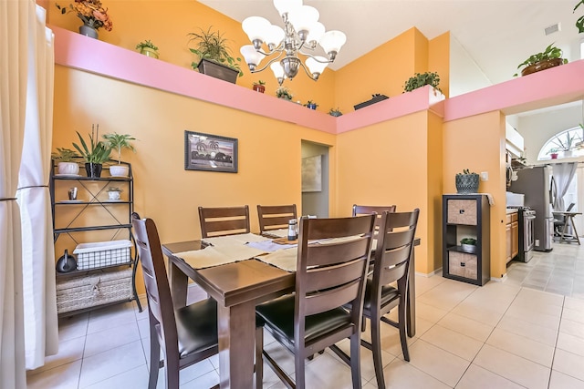 dining area with light tile patterned floors, visible vents, and a chandelier