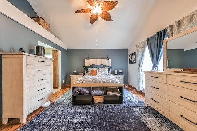 bedroom featuring ceiling fan, lofted ceiling, and wood finished floors