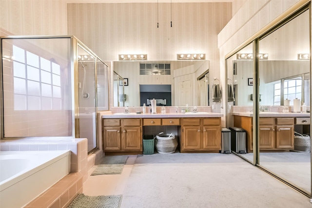 full bathroom with a shower stall, wallpapered walls, vanity, and a garden tub